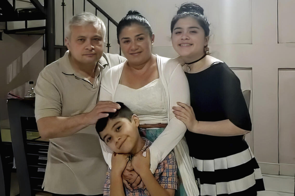 In this June 2020 photo, Xavier Chavarr&iacute;a, left, poses for a photo with his wife Karen Chavarr&iacute;a, center, and their children Karen Azriela Chavarria, right, and son Xavier Yahir Chavarr&iacute;a, in Jinotega, Nicaragua.