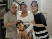 In this June 2020 photo, Xavier Chavarr&iacute;a, left, poses for a photo with his wife Karen Chavarr&iacute;a, center, and their children Karen Azriela Chavarria, right, and son Xavier Yahir Chavarr&iacute;a, in Jinotega, Nicaragua.