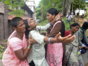 Leela Devi, center, with her arms outstretched, wails after hearing of her husband Chiranjeevi&rsquo;s death in an explosion at the Escientia Advanced Sciences Private Ltd., a pharmaceutical company, outside the mortuary of King George Hospital in Visakhapatnam, Andhra Pradesh state, India, Thursday, Aug. 22, 2024.