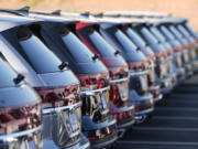 A long row of unsold 2024 Atlas utility vehicles is shown Sunday, July 28, 2024, at a Volkswagen dealership in Denver.