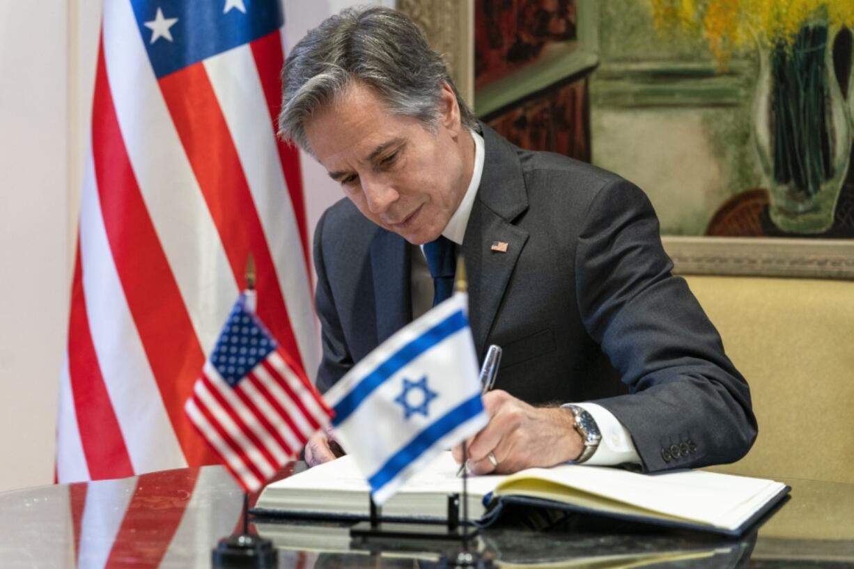 FILE - U.S. Secretary of State Antony Blinken signs a guest book before his meeting with Israel&rsquo;s President Isaac Herzog at the Presidency, Sunday, March 27, 2022, in Jerusalem.