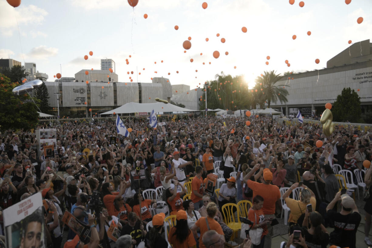 Family, friends and supporters of Ariel Bibas, who is held hostage by Hamas in the Gaza Strip, release orange balloons to mark his fifth birthday in Tel Aviv, Israel, Monday, Aug. 5, 2024. Ariel Bibas, who along with his 1-year-old brother Kfir, has become a symbol of the struggle to free the hostages who remain captive in Gaza. The orange balloons are meant to symbolize Ariel and Kfir&rsquo;s bright red hair.