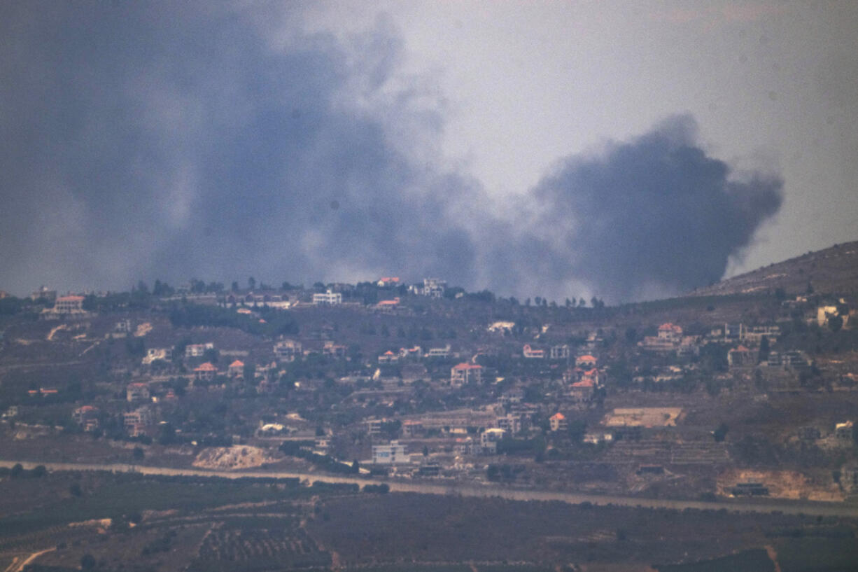 Smoke rises after a strike in an area in Lebanon next to the Israeli-Lebanese border at the Galilee region, as seen from the Israeli-annexed Golan Heights, Sunday, Aug. 4, 2024.