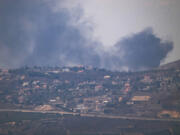 Smoke rises after a strike in an area in Lebanon next to the Israeli-Lebanese border at the Galilee region, as seen from the Israeli-annexed Golan Heights, Sunday, Aug. 4, 2024.