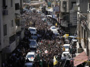 Mourners carry the body of Mahmoud Haroub, 18, during his funeral the day after he was killed in clashes with Israeli forces in the West Bank town of Dura, near Hebron, according to the Palestinian Ministry of Health, Tuesday, Aug. 20, 2024.