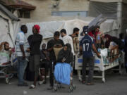 Patients and families move outside the Al-Aqsa Martyrs Hospital in Deir al Balah, Gaza Strip, Sunday, Aug. 25, 2024.