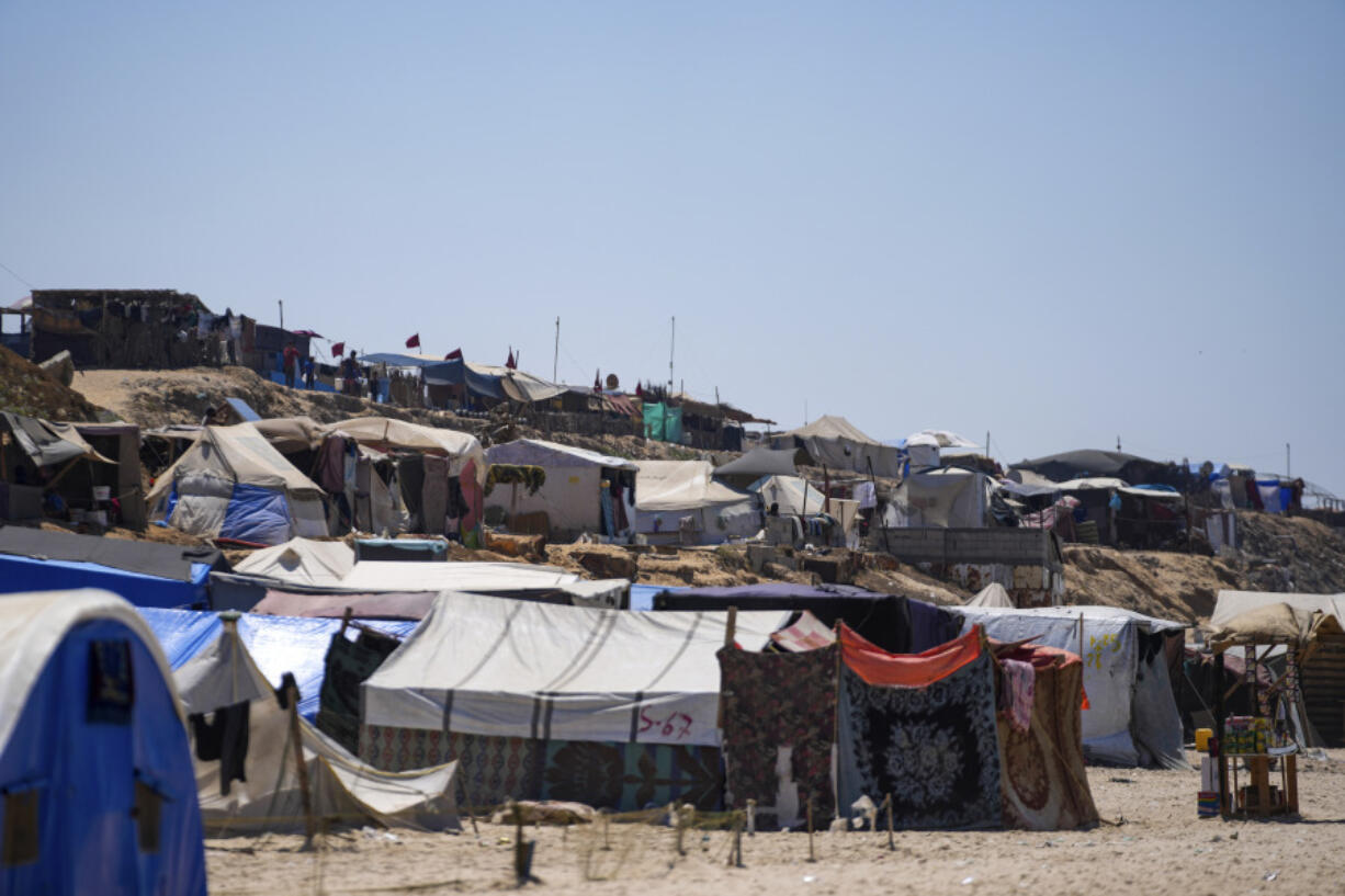 Tents are crammed together as displaced Palestinians camp on the beach, west of Deir al-Balah, Gaza Strip, Tuesday, Aug. 20, 2024.