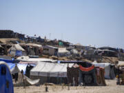 Tents are crammed together as displaced Palestinians camp on the beach, west of Deir al-Balah, Gaza Strip, Tuesday, Aug. 20, 2024.