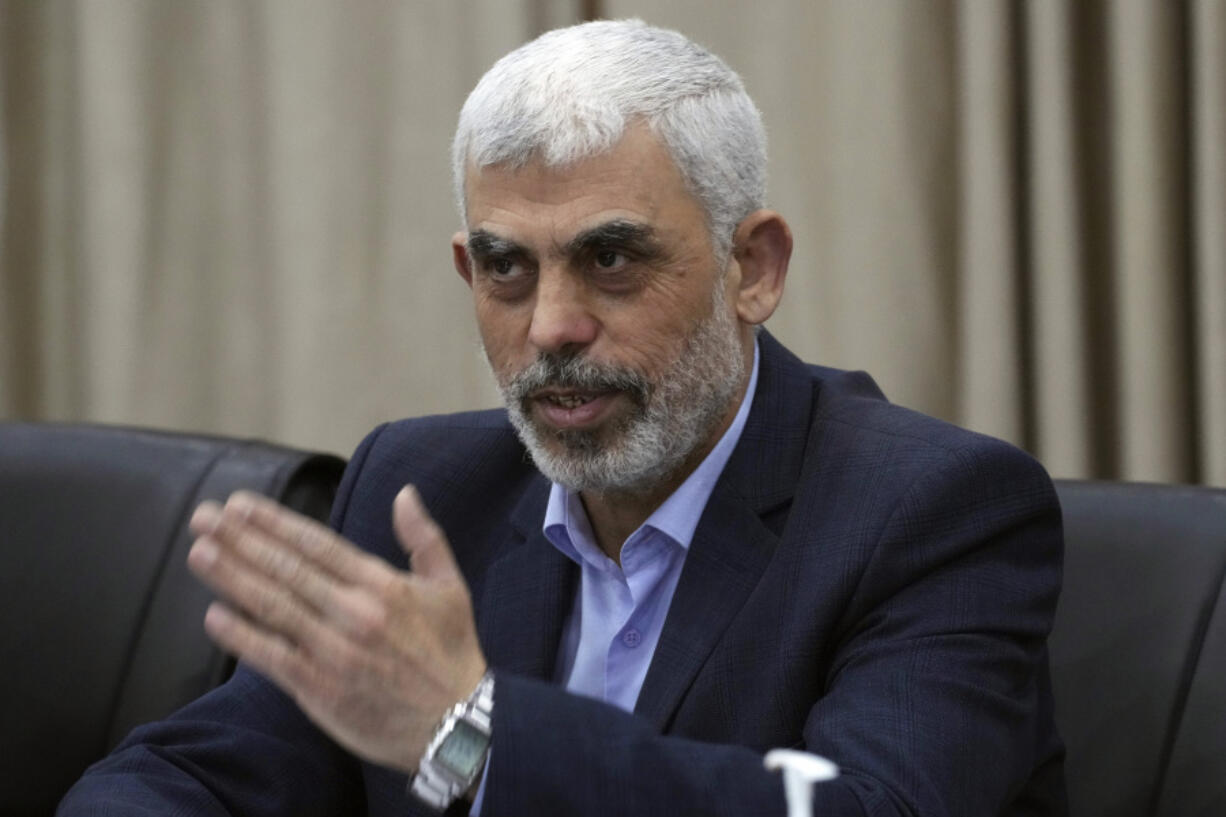 Yahya Sinwar, head of Hamas in Gaza, greets his supporters during a meeting with leaders of Palestinian factions at his office in Gaza City, Wednesday, April 13, 2022.