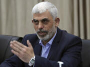 Yahya Sinwar, head of Hamas in Gaza, greets his supporters during a meeting with leaders of Palestinian factions at his office in Gaza City, Wednesday, April 13, 2022.