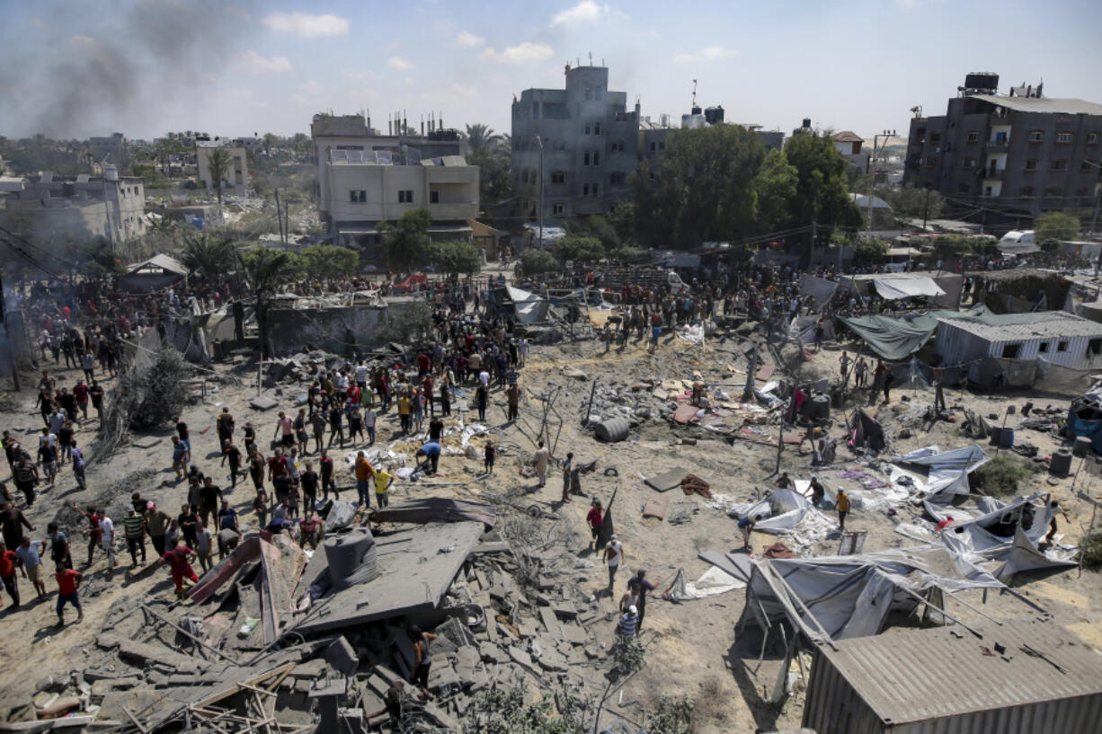 FILE -Palestinians inspect the damage at a site hit by an Israeli bombardment on Khan Younis, southern Gaza Strip, Saturday, July 13, 2024. Israel said it targeted Hamas&rsquo; shadowy military commander Mohammed Deif in a massive strike Saturday in the crowded southern Gaza Strip that killed at least 71 people, according to local health officials.