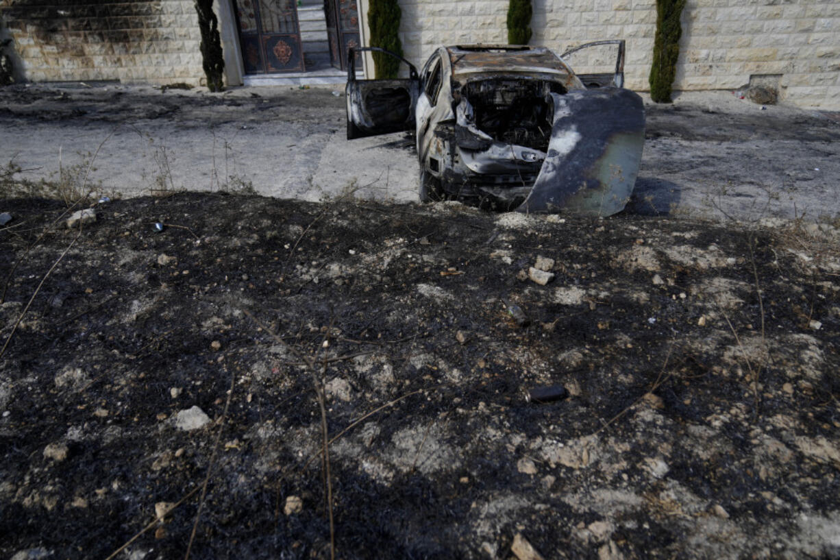 A torched vehicle, seen the morning after a rampage by Israeli settlers in the West Bank village of Jit, Friday, Aug. 16, 2024.