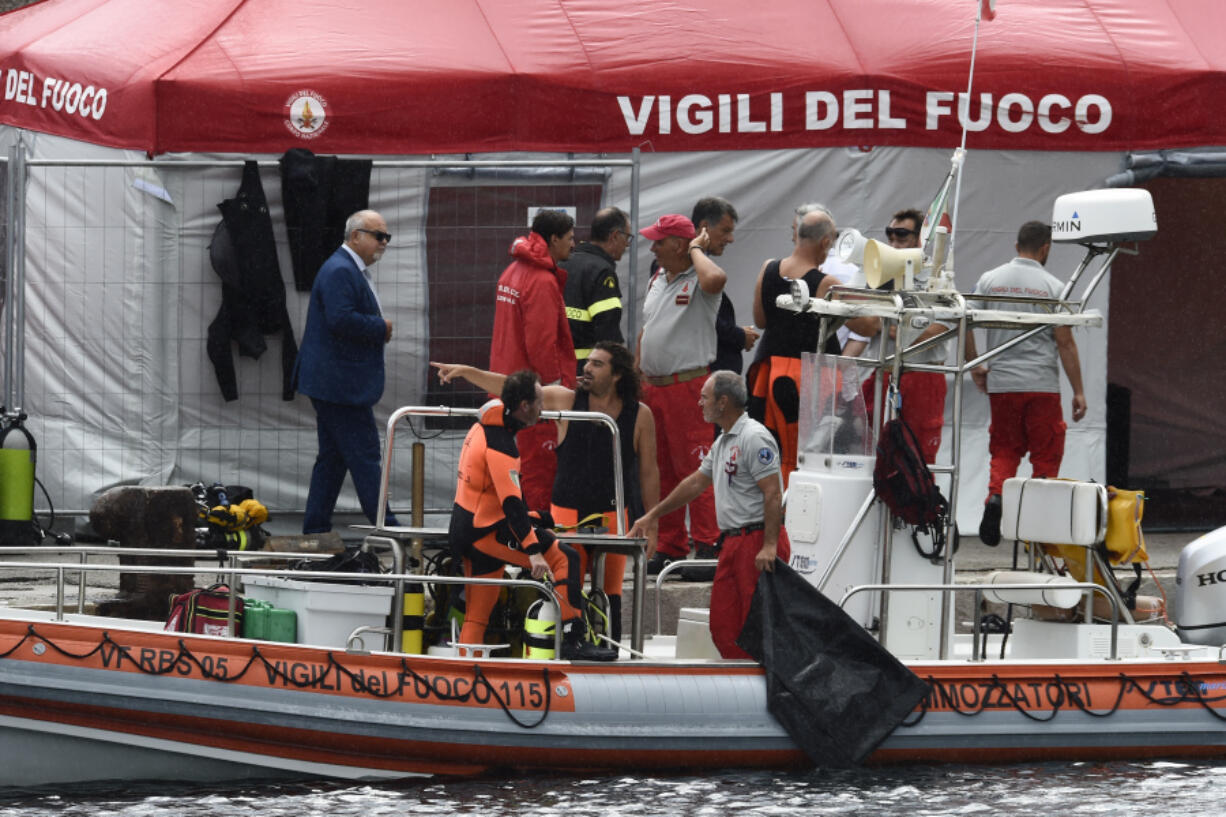 Italian firefighters scuba divers are docked at the harbor of Porticello, southern Italy, Tuesday, Aug. 20, 2024, as rescue teams returned to the site of a storm-sunken superyacht to search for six people, including British tech magnate Mike Lynch, who are believed to be still trapped in the hull 50 meters (164-feet) underwater.