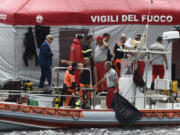 Italian firefighters scuba divers are docked at the harbor of Porticello, southern Italy, Tuesday, Aug. 20, 2024, as rescue teams returned to the site of a storm-sunken superyacht to search for six people, including British tech magnate Mike Lynch, who are believed to be still trapped in the hull 50 meters (164-feet) underwater.