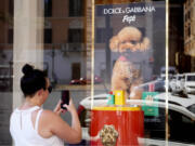 The new Dolce and Gabbana dog perfume called &ldquo;Fefe&rdquo; in honour of Domenico Dolce&rsquo;s dog and released earlier this month is displayed Aug. 6 on the shop window of the fashion brand boutique in Rome. The perfume has been certified suitable for animal use according to the Italian Safe Pet Cosmetics protocol.