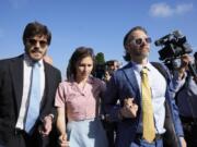 FILE - Amanda Knox arrives flanked by her husband, Christopher Robinson, right, and her lawyer, Luca Luparia Donati, left, at a court in Florence, Italy, June 5, 2024.