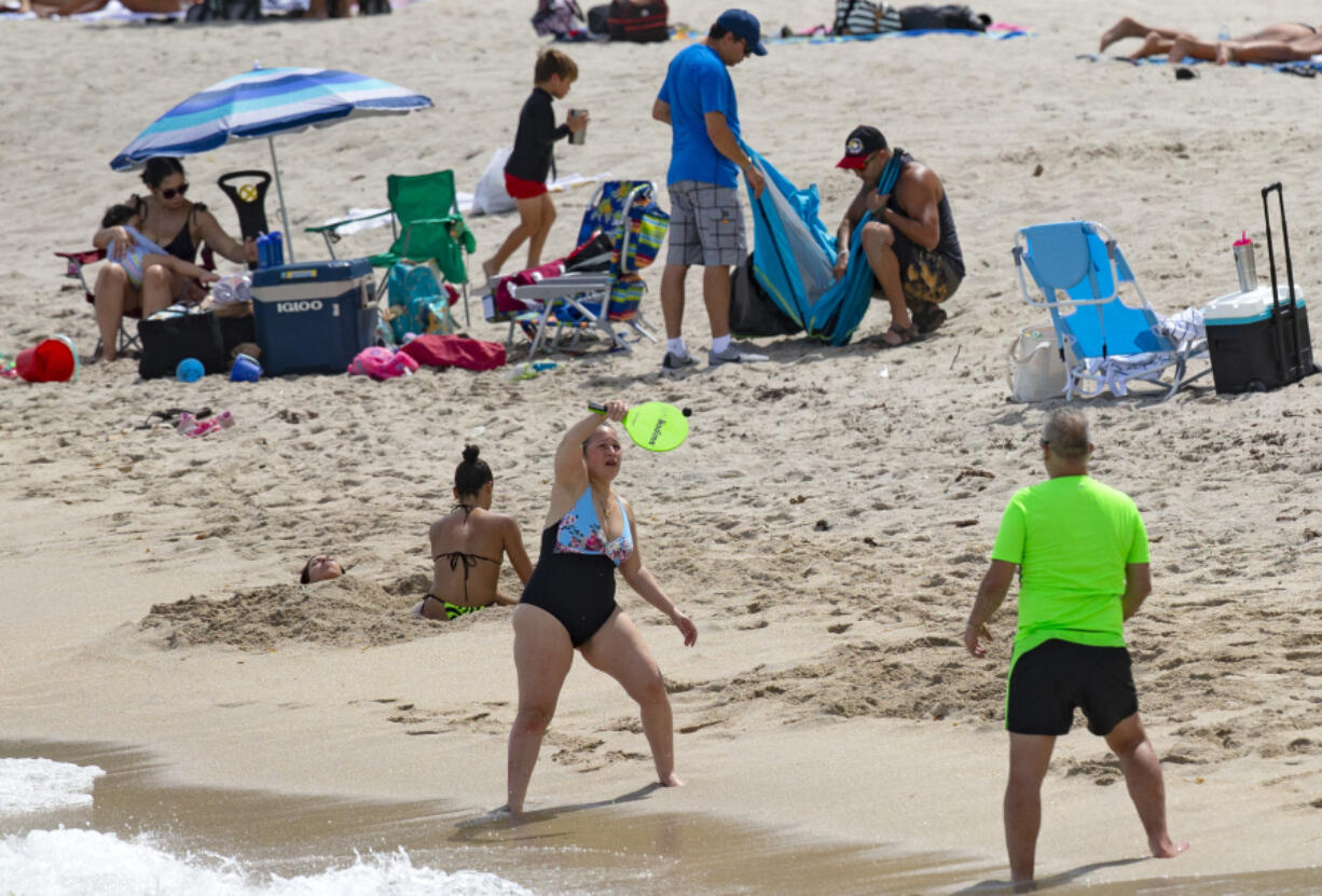 FILE - Beachgoers enjoyed the sunny and hot day at Sunny Isles Beach as the coronavirus pandemic continues on Sunday, Sept. 6, 2020.