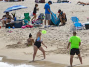 FILE - Beachgoers enjoyed the sunny and hot day at Sunny Isles Beach as the coronavirus pandemic continues on Sunday, Sept. 6, 2020.