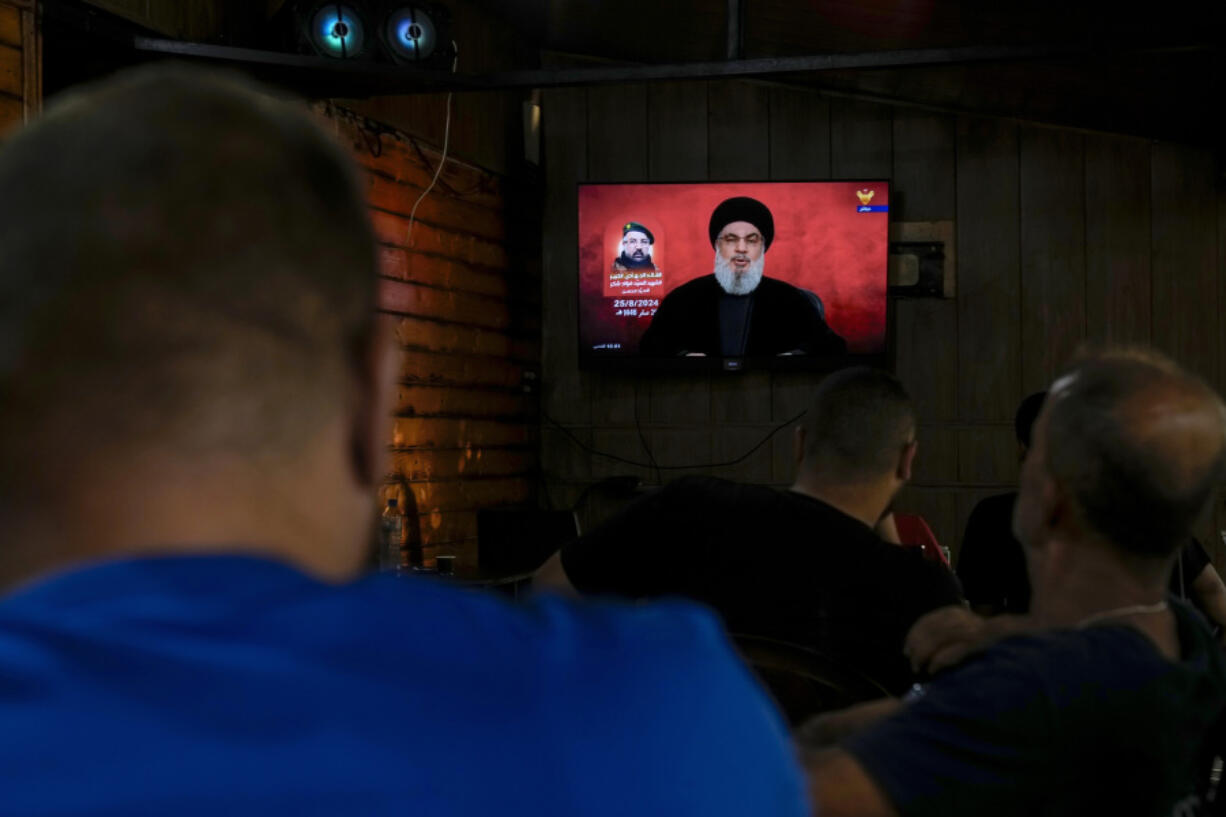 People listen to a speech by Hezbollah leader Sayyed Hassan Nasrallah broadcasted on Hezbollah&#039;s al-Manar television channel, at a coffee shop in a southern suburb of Beirut, Lebanon, Sunday, Aug. 25, 2024, hours after Israel and Hezbollah traded heavy fire.