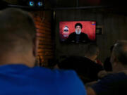 People listen to a speech by Hezbollah leader Sayyed Hassan Nasrallah broadcasted on Hezbollah&#039;s al-Manar television channel, at a coffee shop in a southern suburb of Beirut, Lebanon, Sunday, Aug. 25, 2024, hours after Israel and Hezbollah traded heavy fire.