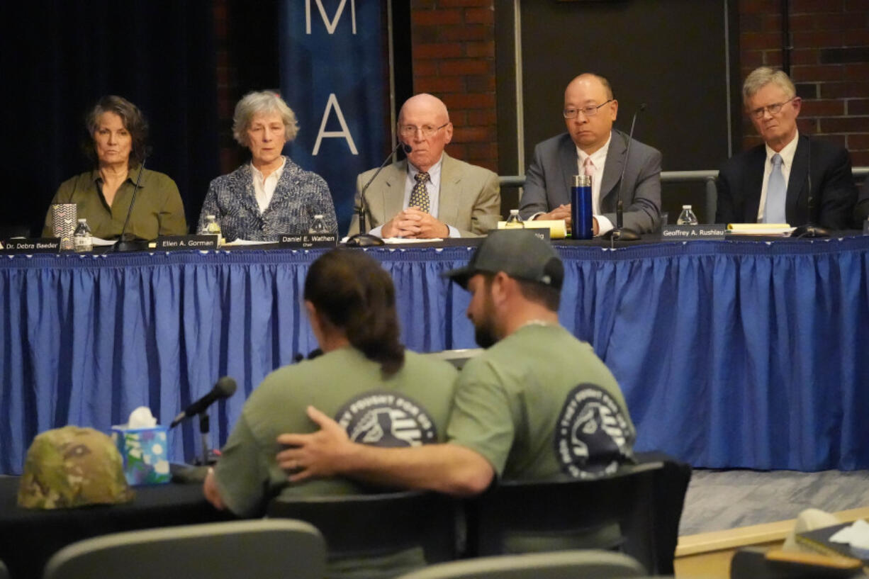 FILE &mdash; Members of the independent commission investigating the law enforcement response to the mass shooting in Lewiston, Maine, listen as Nicole Herling, below left, sister of shooter Robert Card, testifies Thursday, May 16, 2024, in Augusta, Maine. (AP Photo/Robert F.