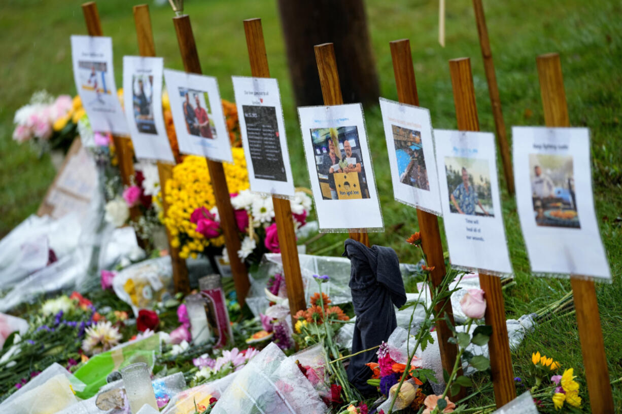 FILE - Rain-soaked memorials for those who died in a mass shooting sit along the roadside by Schemengees Bar &amp; Grille, Oct. 30, 2023, in Lewiston, Maine.