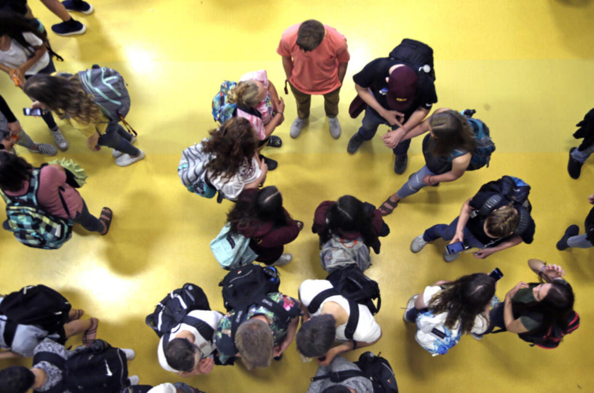 FILE - Students gather in a common area as they head to classes in Oregon, May 4, 2017.