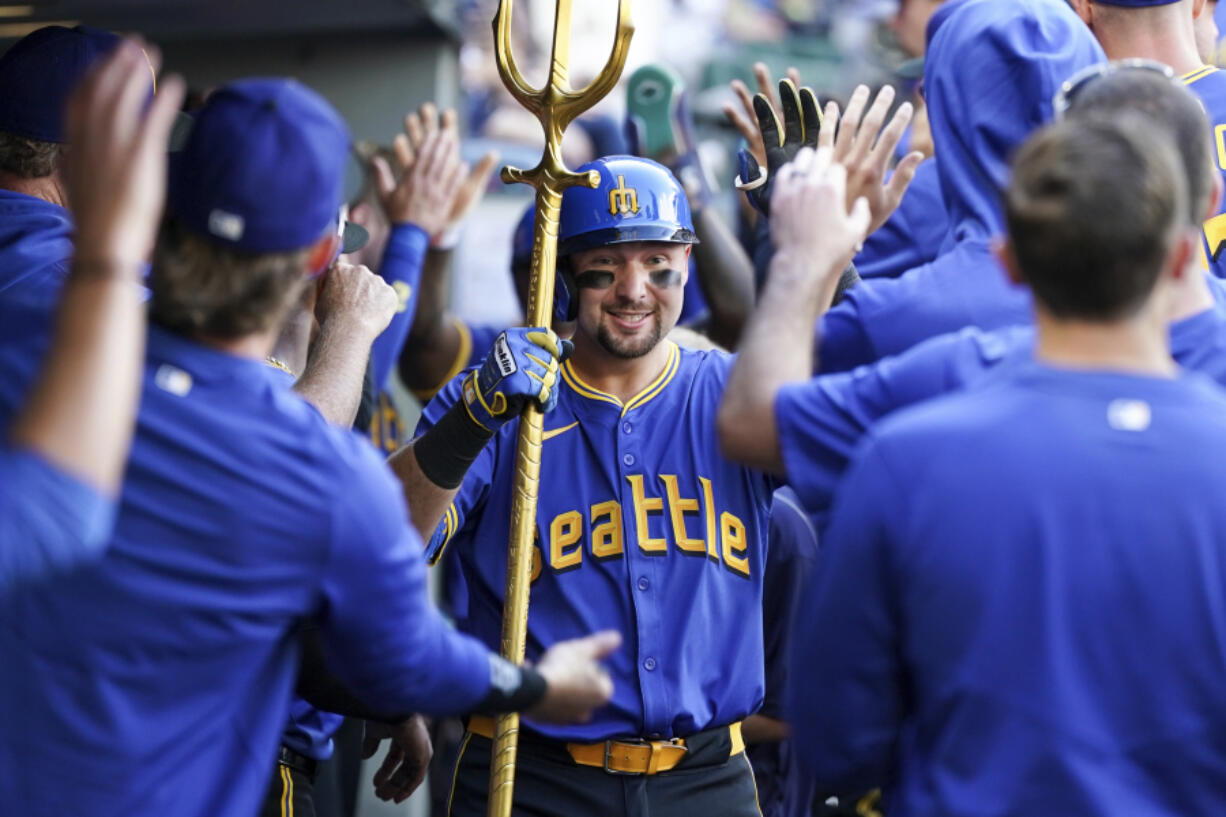 Seattle Mariners&#039; Cal Raleigh celebrates with teammates after hitting a home run during the sixth inning of a baseball game against the New York Mets, Sunday, Aug. 11, 2024, in Seattle.