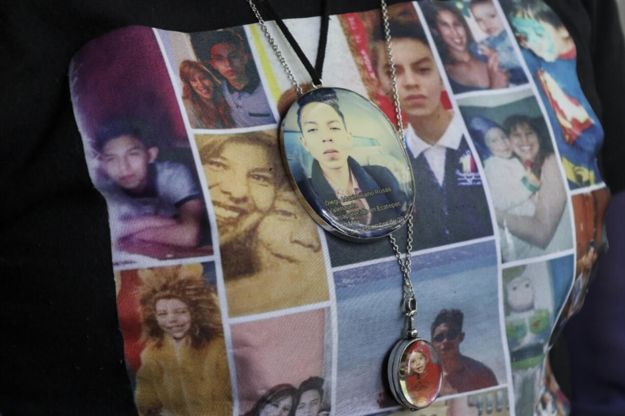 Photos of Veronica Rosas and her son Diego decorate Veronica&rsquo;s shirt and necklaces, as she poses for a portrait at her home in Ecatepec, Mexico, Friday, Aug. 2, 2024. Rosas&rsquo; son went missing when he was 16 years old on Sept. 4, 2015.