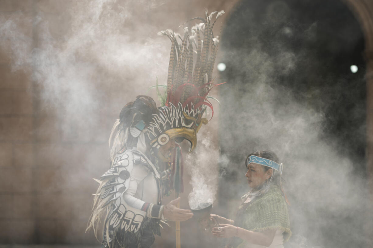 Mexica dancers burn incense during an Aug. 13 ceremony commemorating the 503rd anniversary of the fall of the Aztec empire&rsquo;s capital, Tenochtitlan, in Mexico City.