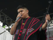 Mexican-Triqui artist Carlos CGH, wearing a black and red &ldquo;gab&aacute;n,&rdquo; a garment native to the Triqui people in western Oaxaca, performs during a celebration of Indigenous peoples at the Zocalo in Mexico City, Tuesday, Aug. 6, 2024.