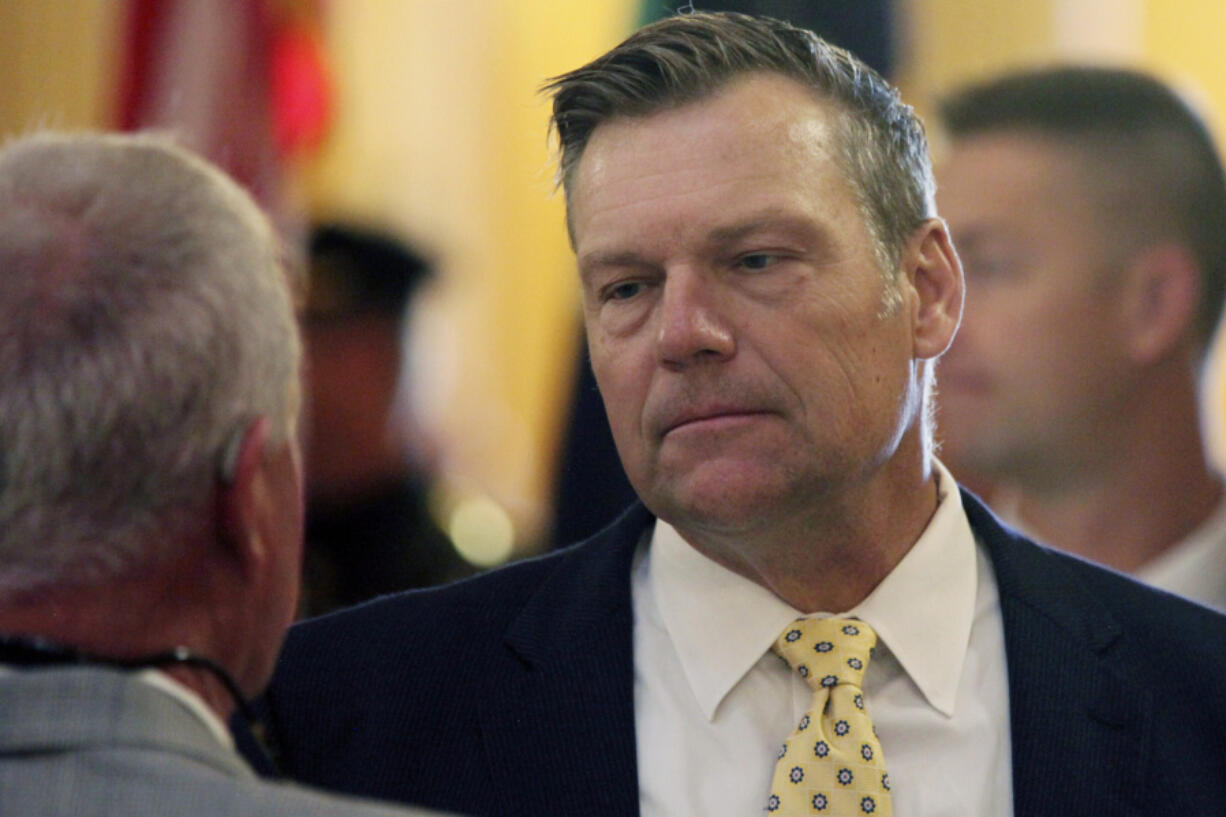 FILE - Kansas Attorney General Kris Kobach participates in a ceremony honoring fallen law enforcement officers, Friday, May 3, 2024, at the Statehouse in Topeka, Kan. Kansas is one of 15 states that filed a federal lawsuit Thursday, Aug. 8, 2024, against the Biden administration over a rule that is expected to allow 100,000 immigrants brought to the U.S. illegally as children to enroll next year in the federal Affordable Care Act&rsquo;s health insurance.