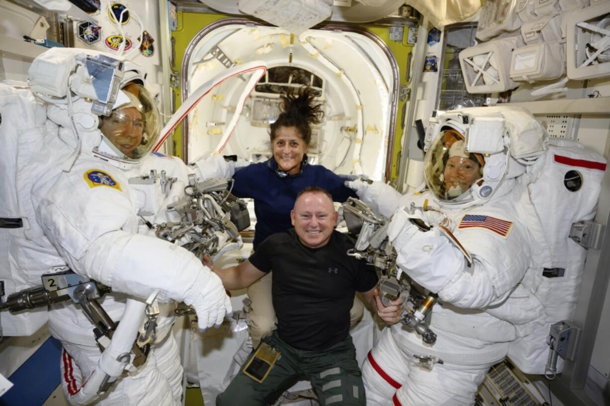 FILE - In this photo provided by NASA, Boeing Crew Flight Test astronauts Suni Williams and Butch Wilmore, center, pose with Expedition 71 Flight Engineers Mike Barratt, left, and Tracy Dyson, aboard the International Space Station&#039;s Quest airlock on June 24, 2024.