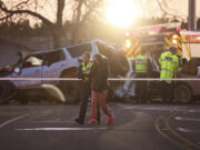 A police officer comforts a woman at a crash site near Geraldine, New Zealand, where South Korean skiers are involved in a fatal accident, Thursday, Aug. 22, 2024.