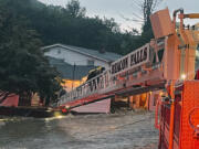 This photo provided by Beacon Hose Co. No. 1, a fire station in Beacon Falls, Connecticut, shows members of Beacon Hose Co. rescuing people from the Brookside Inn in Oxford, Conn., Sunday, Aug. 18, 2024.