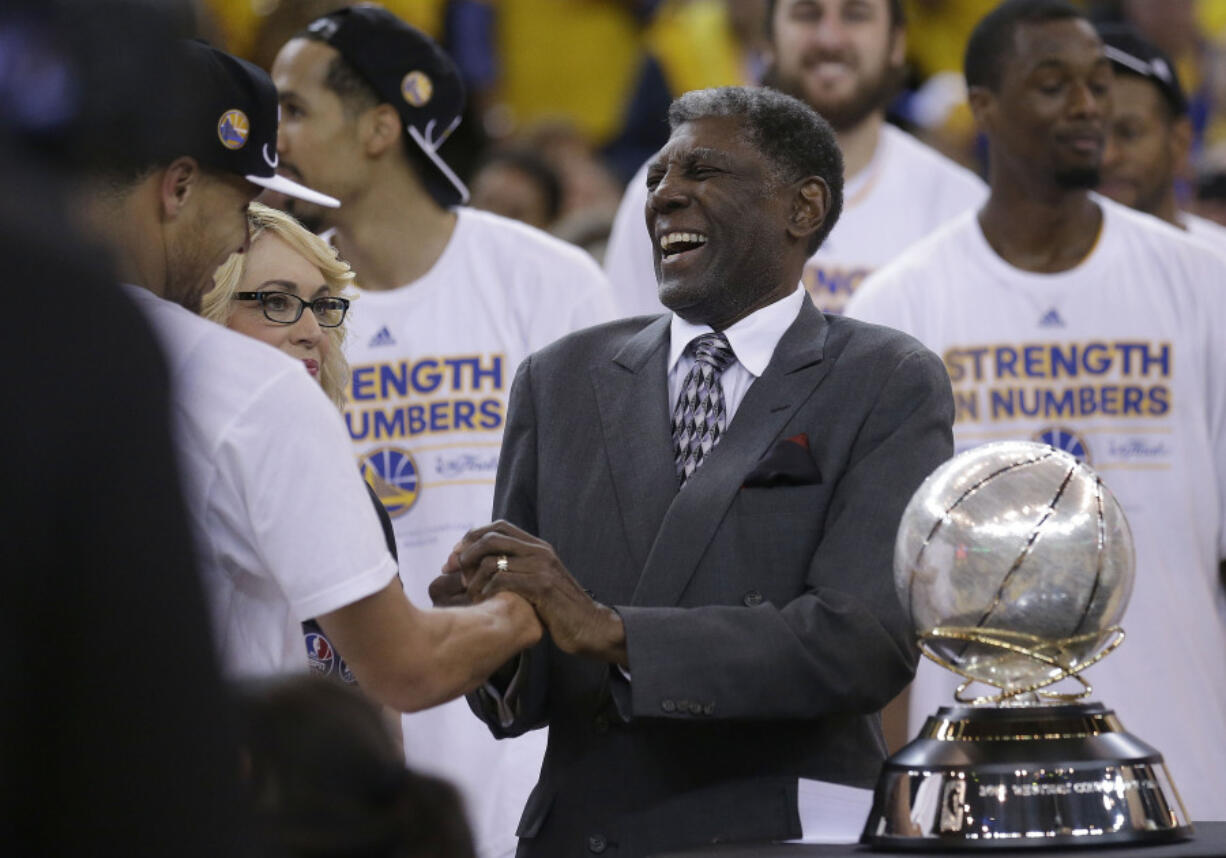 FILE -G olden State Warriors guard Stephen Curry, left, shakes hands with former coach Al Attles after Game 5 of the NBA basketball Western Conference finals against the Houston Rockets in Oakland, Calif., Wednesday, May 27, 2015.