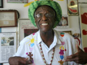 FILE - Wally Amos, of Kailua, Hawaii, is shown in his home office on June 12, 2007, in the Lanikai section of Kailua, Hawaii. Amos, the creator of the cookie empire that took his name and made it famous and who went on to become a children&rsquo;s literacy advocate, has died at age 88, on Tuesday, Aug. 13, 2024.