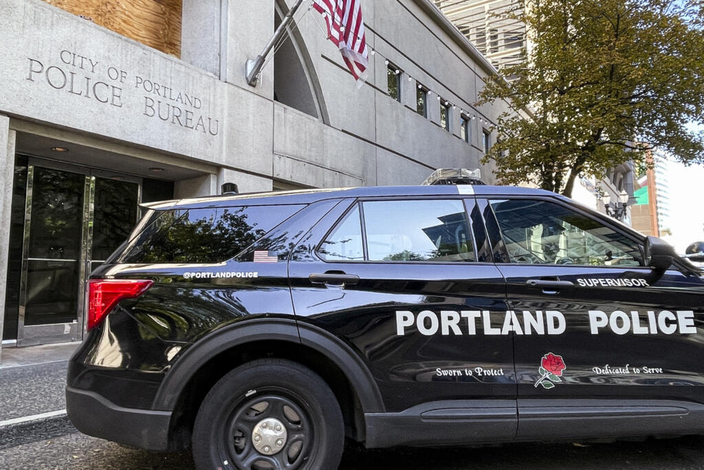 A police vehicle is parked outside police headquarters in Portland, Ore., Friday, Aug. 30, 2024.