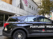 A police vehicle is parked outside police headquarters in Portland, Ore., Friday, Aug. 30, 2024.