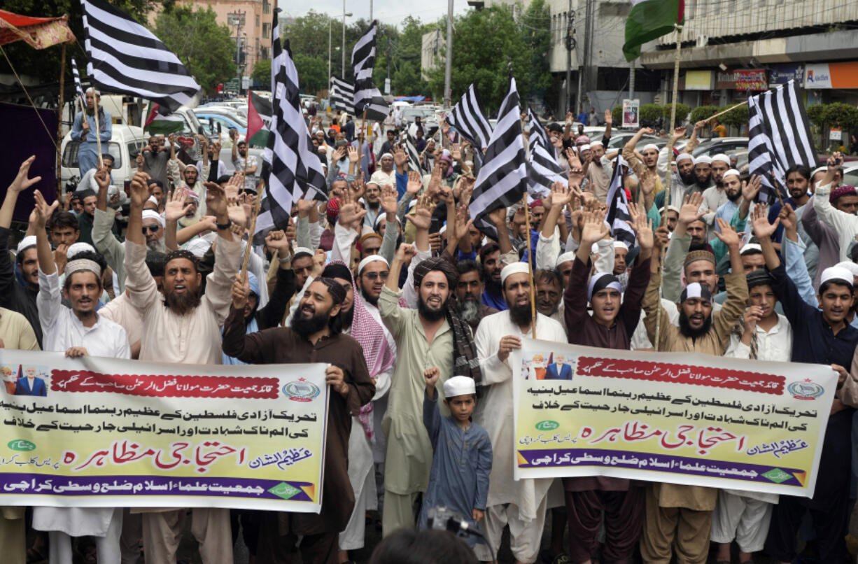 Supporters of political party Jamiat Ulema-e-Islam, chant slogans during a protest to condemn the killing of Hamas leader Ismail Haniyeh, who was killed in an assassination in Tehran, in Karachi, Pakistan, Friday, Aug. 2, 2024.