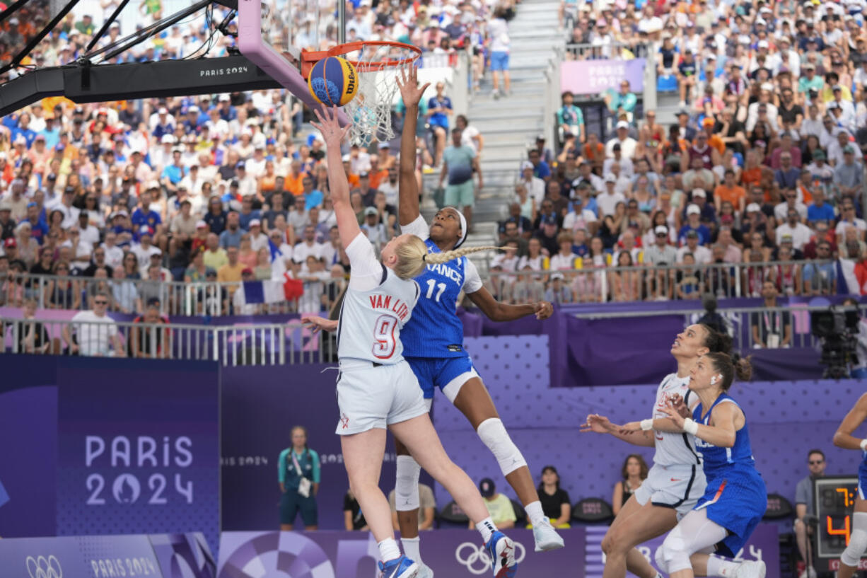 Hailey van Lith (9), of the United States, drives past Myriam Djekoundade (11), of France, in the women&#039;s 3x3 basketball pool round match during the 2024 Summer Olympics, Friday, Aug. 2, 2024, in Paris, France. The United States won 14-13.