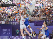 Hailey van Lith (9), of the United States, drives past Myriam Djekoundade (11), of France, in the women&#039;s 3x3 basketball pool round match during the 2024 Summer Olympics, Friday, Aug. 2, 2024, in Paris, France. The United States won 14-13.