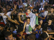 Supporters and relatives watch Algerian boxer Imane Khelif competing in the women&rsquo;s 66-kg boxing Olympic final match in Bibane Mesbah, near Tiaret, Algeria, Friday , Aug. 9, 2024.