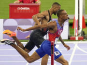 Quincy Hall, of the United States, crosses the finish line followed by Matthew Hudson-Smith, of Britain, in the men&rsquo;s 400-meters final at the 2024 Summer Olympics, Wednesday, Aug. 7, 2024, in Saint-Denis, France.