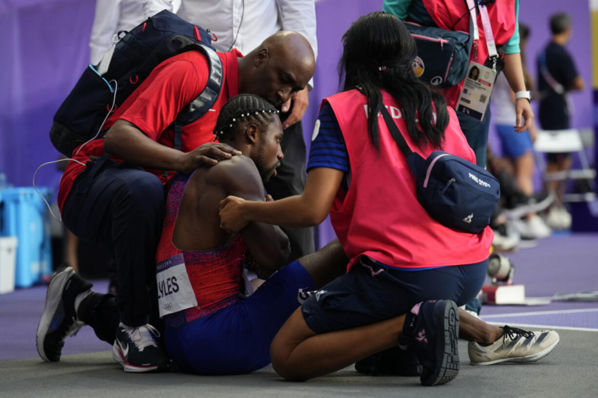 Noah Lyles, of the United States, is tended to by medical staff following the men&#039;s 200-meters final at the 2024 Summer Olympics, Thursday, Aug. 8, 2024, in Saint-Denis, France.