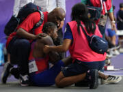 Noah Lyles, of the United States, is tended to by medical staff following the men&#039;s 200-meters final at the 2024 Summer Olympics, Thursday, Aug. 8, 2024, in Saint-Denis, France.