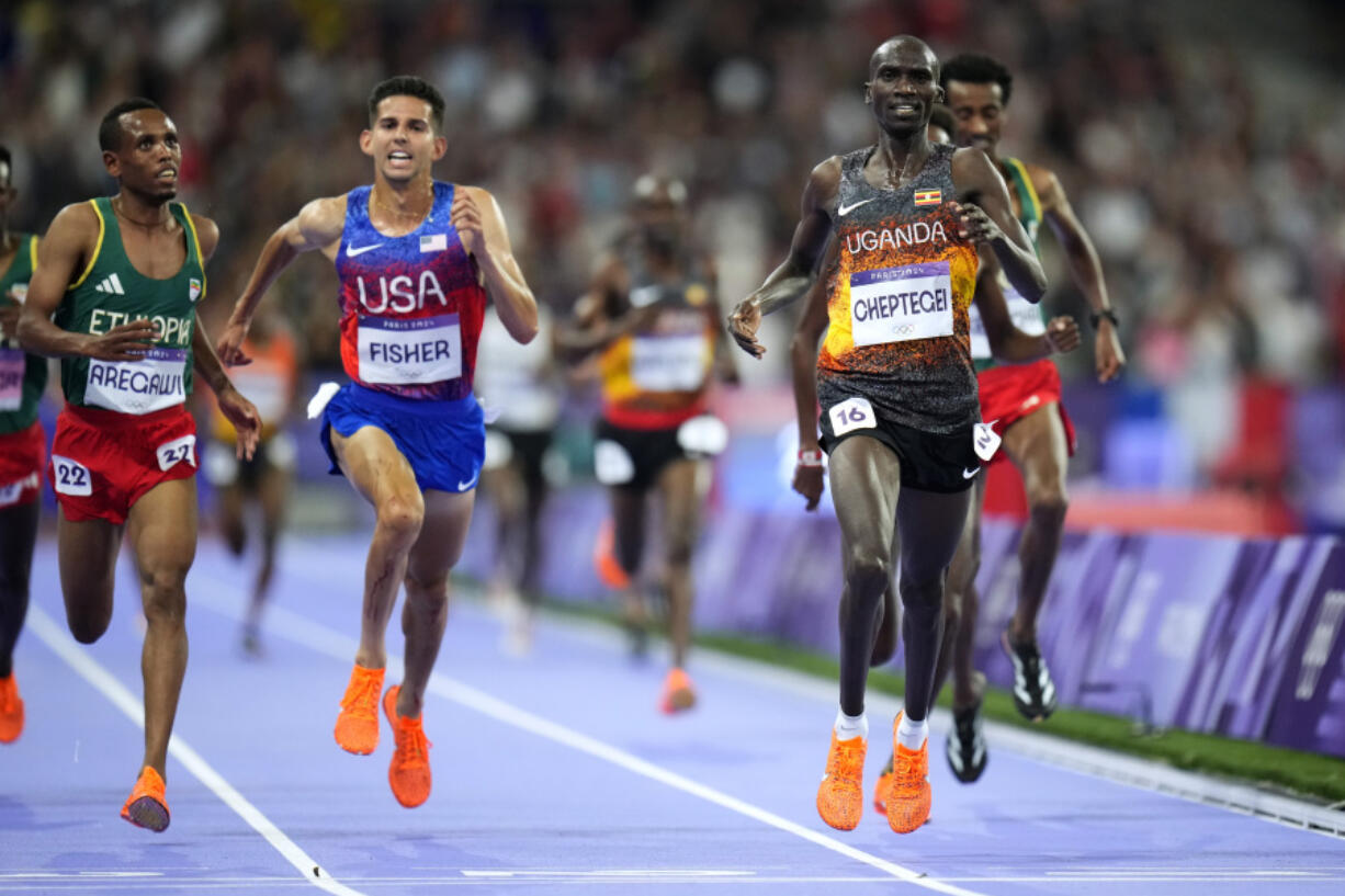 Joshua Cheptegei, of Uganda, celebrates after winning the wins the men&rsquo;s 10,000-meter final at the 2024 Summer Olympics, Friday, Aug. 2, 2024, in Saint-Denis, France.