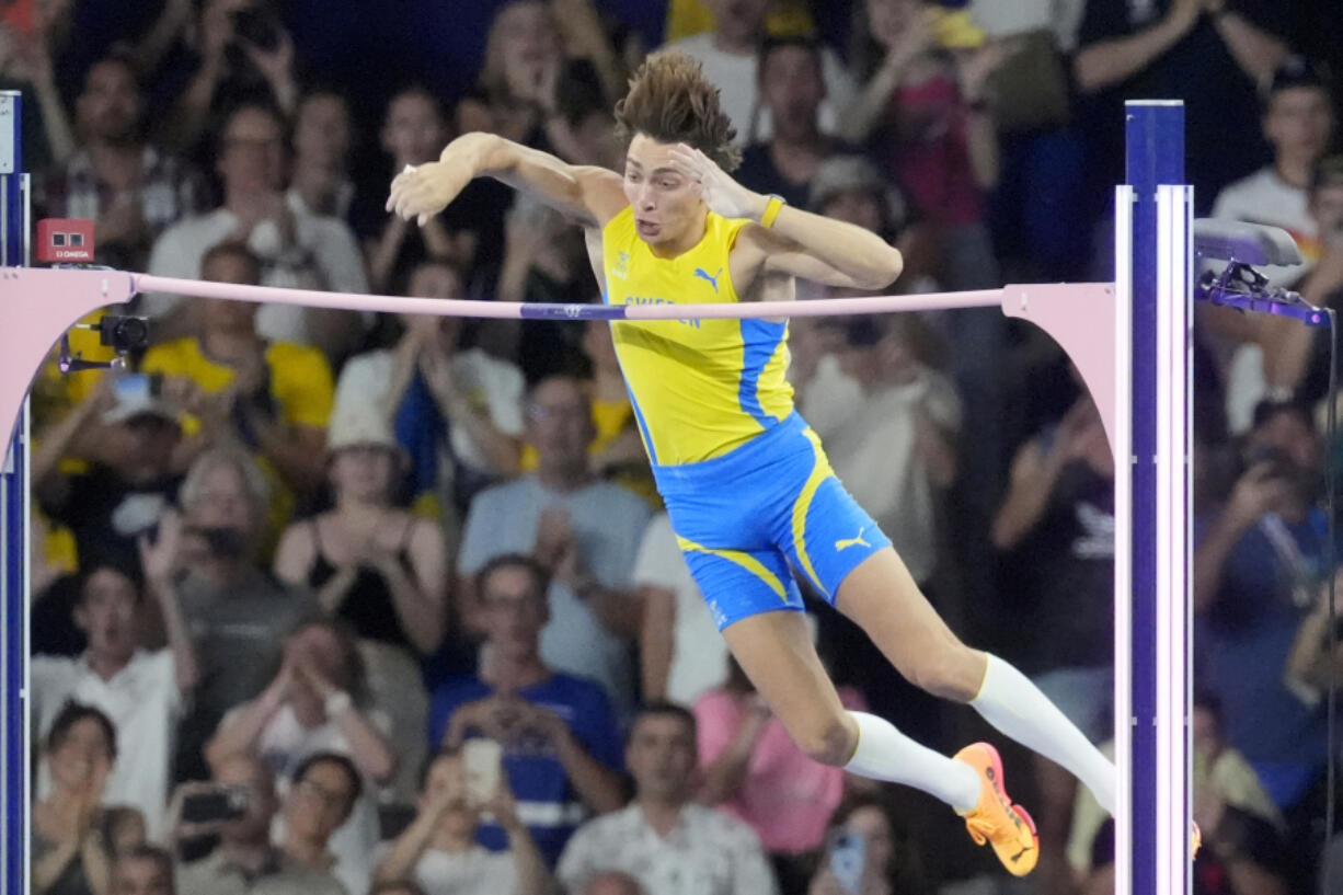 Armand Duplantis, of Sweden, clears the bar at 6.25 to set a new world record during the men&rsquo;s pole vault final at the 2024 Summer Olympics, Monday, Aug. 5, 2024, in Saint-Denis, France.