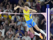 Armand Duplantis, of Sweden, clears the bar at 6.25 to set a new world record during the men&rsquo;s pole vault final at the 2024 Summer Olympics, Monday, Aug. 5, 2024, in Saint-Denis, France.