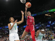 United States&rsquo; A&rsquo;ja Wilson (9) shoots between Pallas Kunayi Akpanah (3) and Ezinne Kalu (23), of Nigeria, during a women&rsquo;s quarterfinal game at Bercy Arena at the 2024 Summer Olympics, Wednesday, Aug. 7, 2024, in Paris, France. (AP Photo/Mark J.